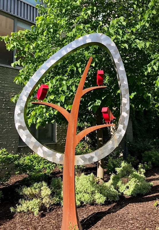 Stylized sculpture of birds in a tree
