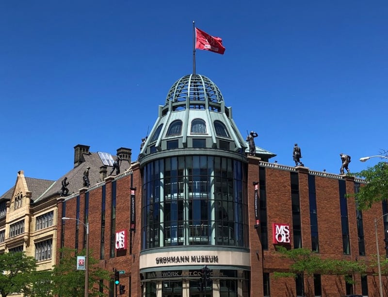 Sculptures ring the roofline of the Grohman Museum