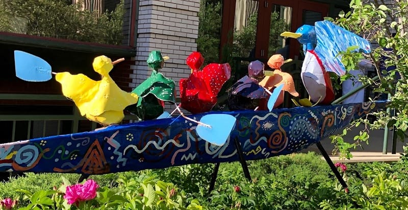 Fun sculpture of a duck rowing team