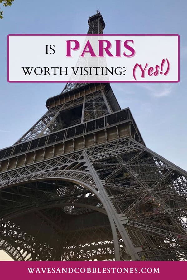 Is Paris worth visiting pin; view of the Eiffel Tower from the base looking upwards to the blue sky.